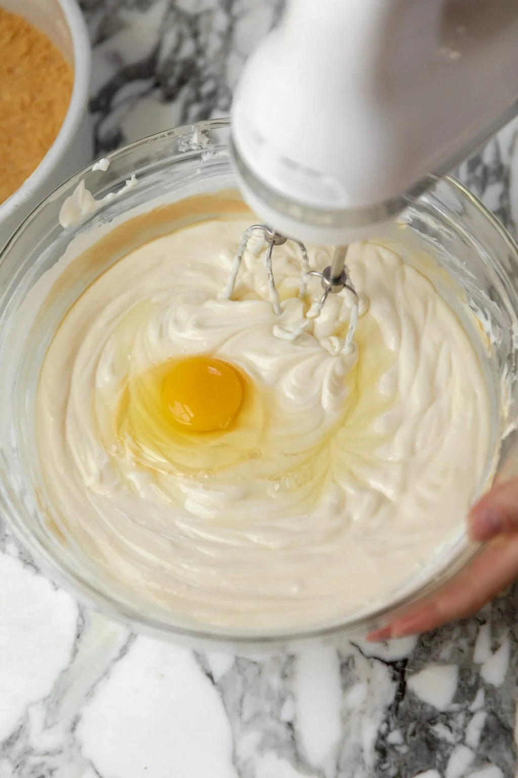 mixing an egg into the cream cheese filling